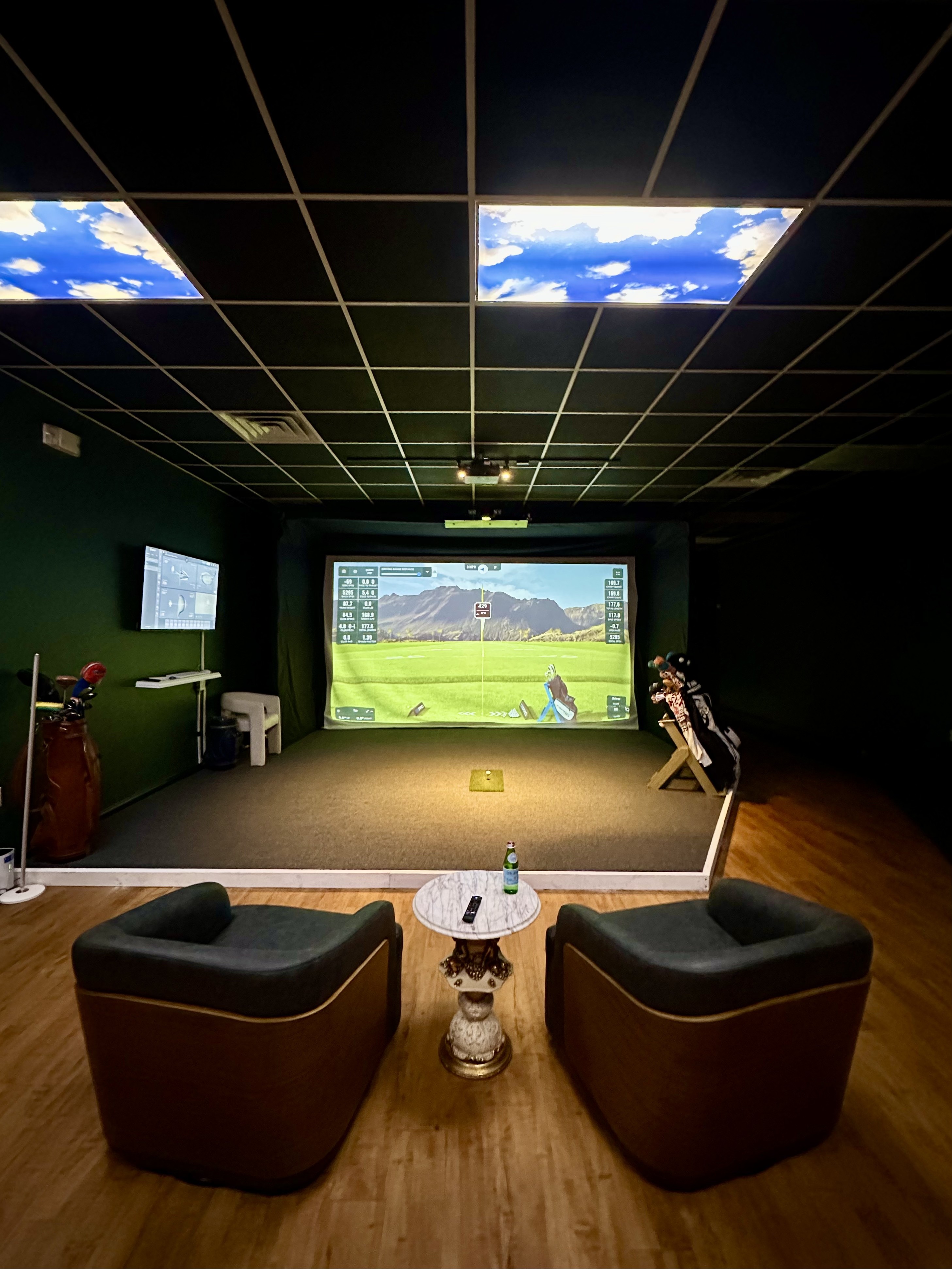 Indoor golf simulator studio with high-tech projection screen